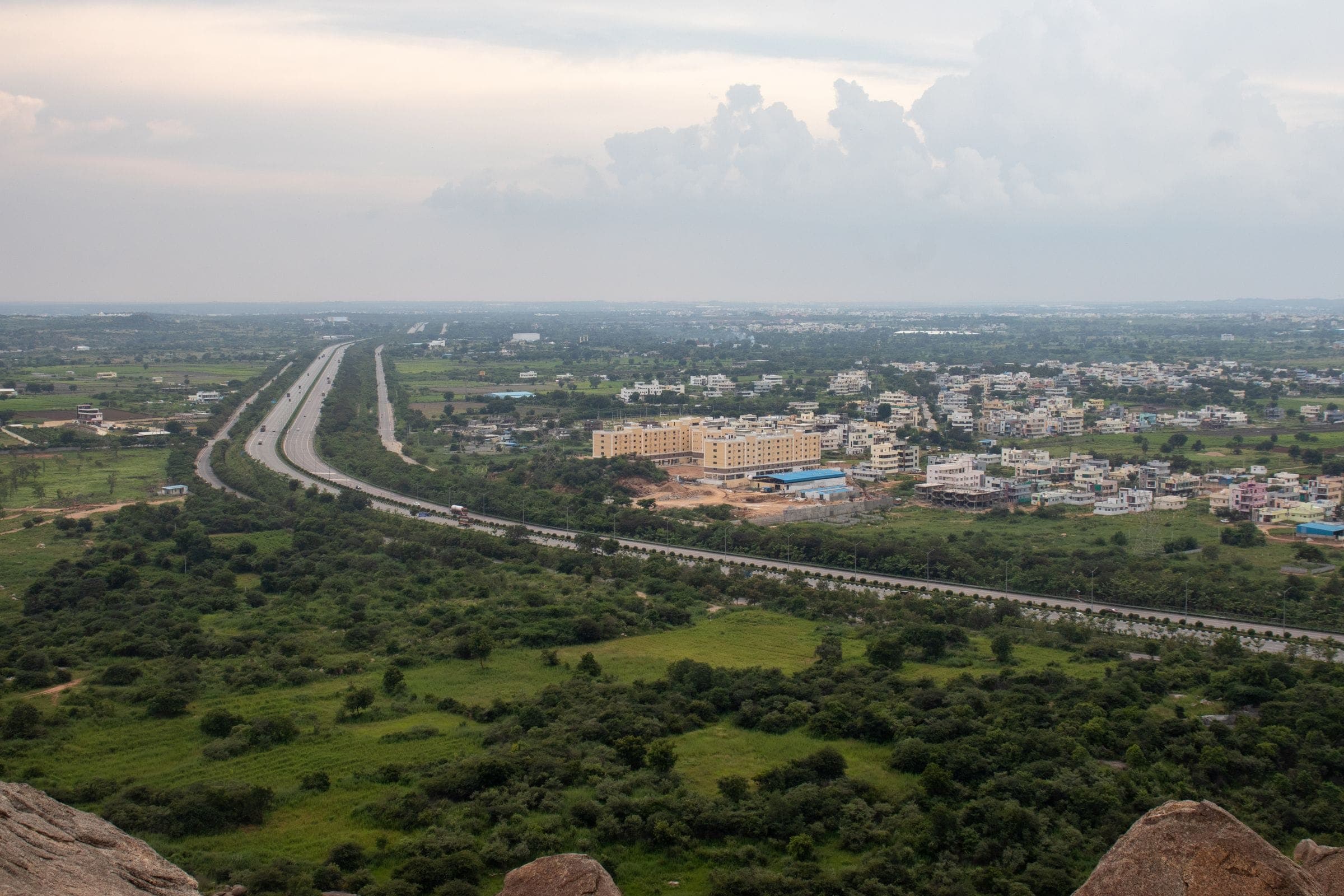Aerial view of an expressway running through green countryside